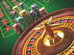 A roulette wheel with chips and the board in the background