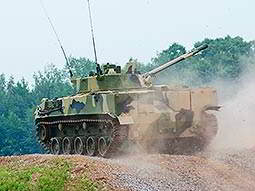 A camouflage-patterned tank on a hill