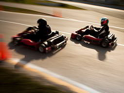 Two go karts racing on an outdoor circuit