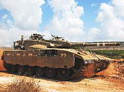 A main battle tank on a dirt track