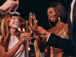 A group of hens clinking their glasses of cava at a party in Benidorm