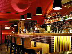 Bar stools in front of a yellow bar