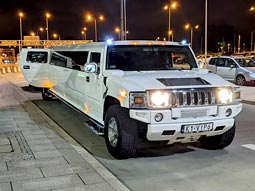 A hummer limo waiting to pick up a group at the airport