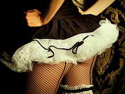 A woman wearing a tutu and fish net tights 