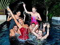 A group of men and women in a water pool