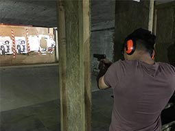A man about to fire a gun at a target