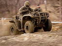 A man driving a quad bike through the wilderness