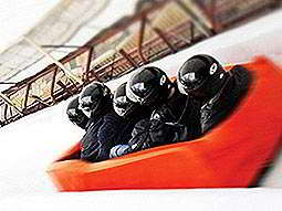 Five people sat in a red soft bobsleigh on an ice track as part of a stag do in Riga