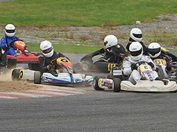 Aix people driving go karts with one driving in the wrong direction