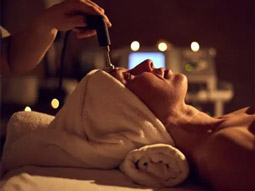A close up of a woman on a massage bed receiving a facial treatment in Benidorm