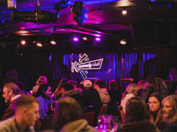 The word Comedy lit up in lights 