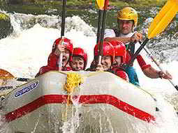 Some people in an inflated raft, white water rafting