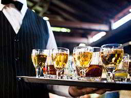 Five women holding champagne flutes in front of them