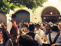 People sat on benches outside a beerhall