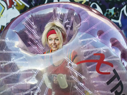A woman in an inflatable pink bubble