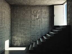 An empty room with a staircase leading outside