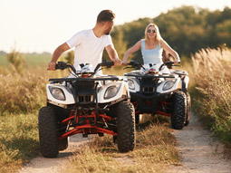 A girl on a quad bike in the sun
