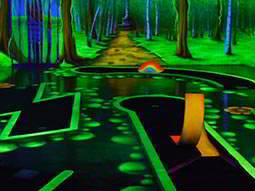 The green-lit interior of a glow golf course