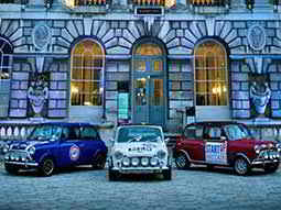 Red, White and Blue Mini Coopers outside a building in London