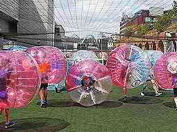 People in inflatable zorbs in a field