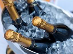 Four bottles of champagne chilling in an ice bucket