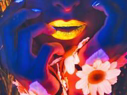 Close up of a woman's face with yellow lips, to a blue backdrop