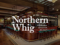 A bar with bar stools along the side of it at Northern Whig in Belfast