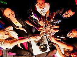 Top-down view of a group of people raising glasses and clinking them together