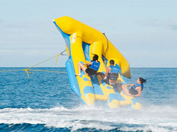 Two people holding onto a Fly Fish boat