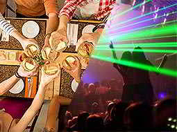 A split image of people clinking their glasses together and a club with green laser lights