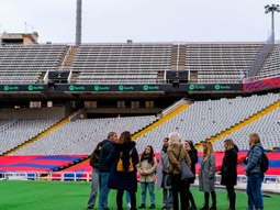 Barcelona FC logo over a blurred image of the pitch at Nou Camp