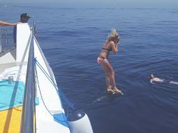 A woman jumping off a boat in the sea