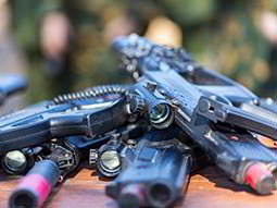 Laser tag guns piled on top of each other on a table