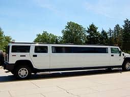 A white hummer, parked up during the day
