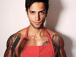 A semi-naked man in a red apron