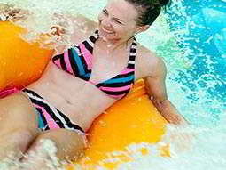 A woman on an inflatable ring in a plunge pool