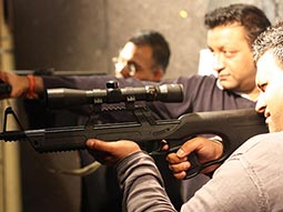 Some men firing guns in a shooting range