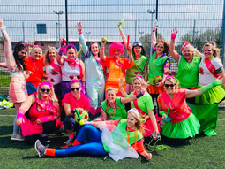 A group of women wearing neon outfits at Olympic Shames