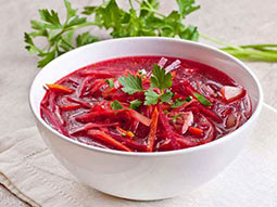 Some Polish food in a white bowl, on a table
