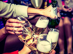 A close up of people holding glasses of champagne 