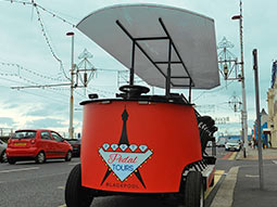 A red pedal bus, parked up outside