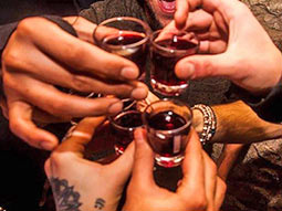 A close up of a group of people putting shots together