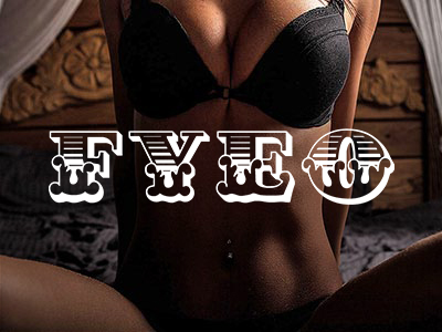 The body of a woman wearing black lingerie and sitting on a bed