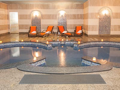 A spa room with a swimming pool