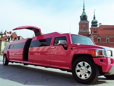 A pink hummer parked up outside with the door open