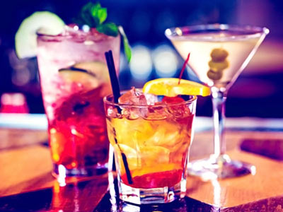 Three different coloured cocktails on a table