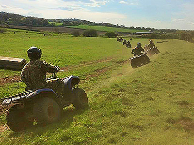 People driving quad bikes into the distance