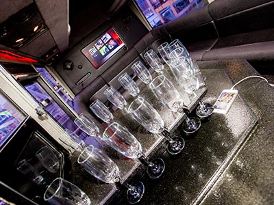 A number of champagne glasses on a table in a party bus