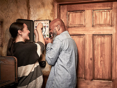 Two people solving a puzzle together at an Escape Room Experience