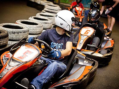 A group of people in go-karts about to start a race